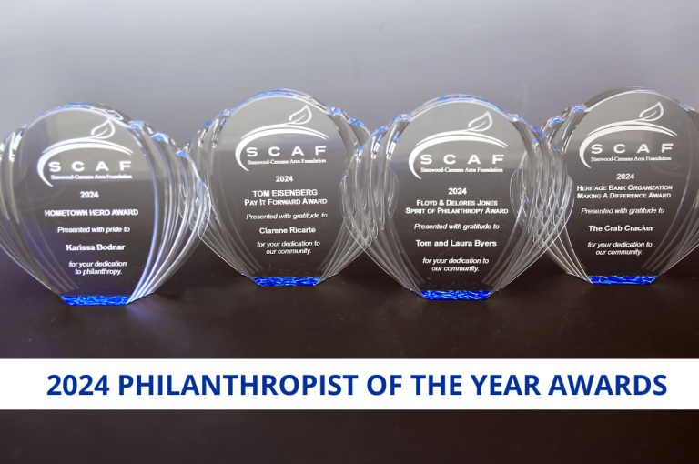 A photo of 4 clear, engraved awards celebrating the 2024 Philanthropist of the Year award winners